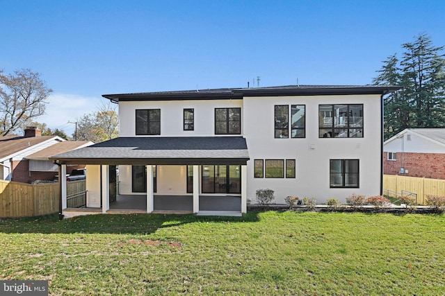 rear view of property with a yard