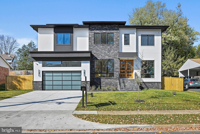 modern home featuring a garage and a front lawn