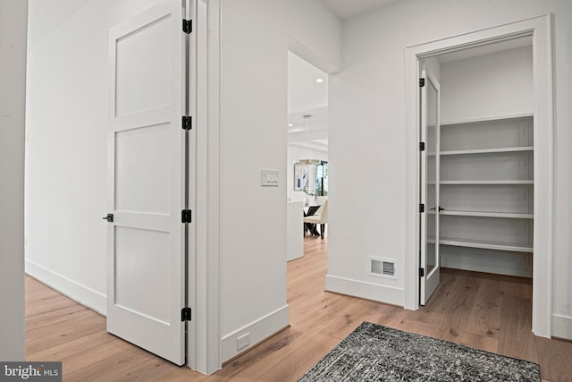 hallway with light hardwood / wood-style flooring