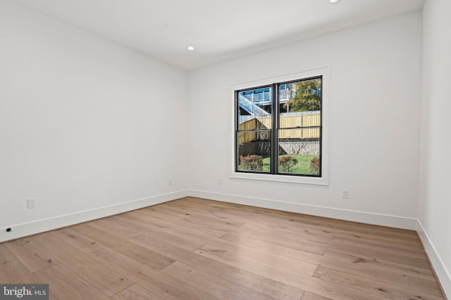 spare room with light hardwood / wood-style flooring