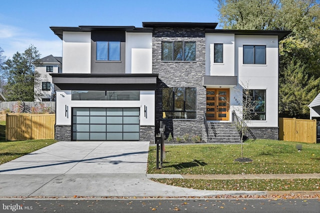 contemporary home with a front yard and a garage