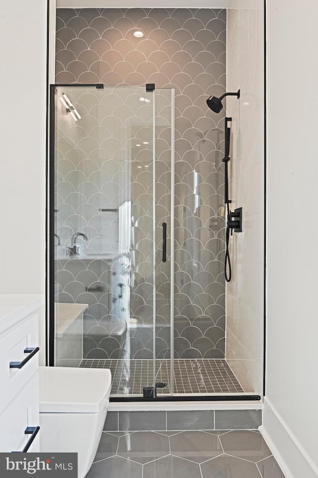 bathroom with an enclosed shower, vanity, and toilet