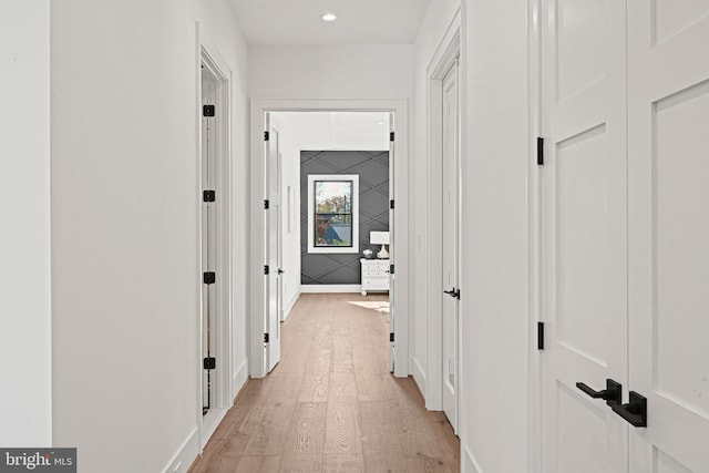 corridor with light wood-type flooring