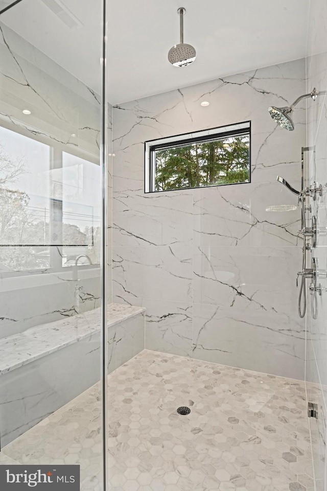 bathroom featuring a tile shower