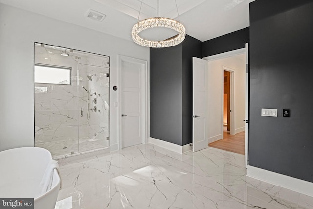 bathroom featuring separate shower and tub and an inviting chandelier