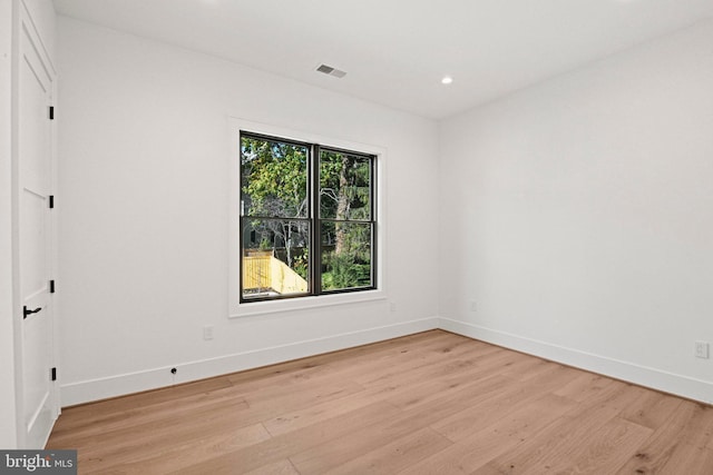 unfurnished room with light wood-type flooring