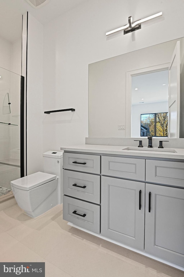 bathroom with tile patterned floors, a shower with door, vanity, and toilet