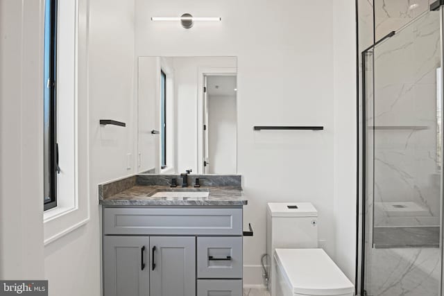 bathroom featuring vanity, toilet, and an enclosed shower