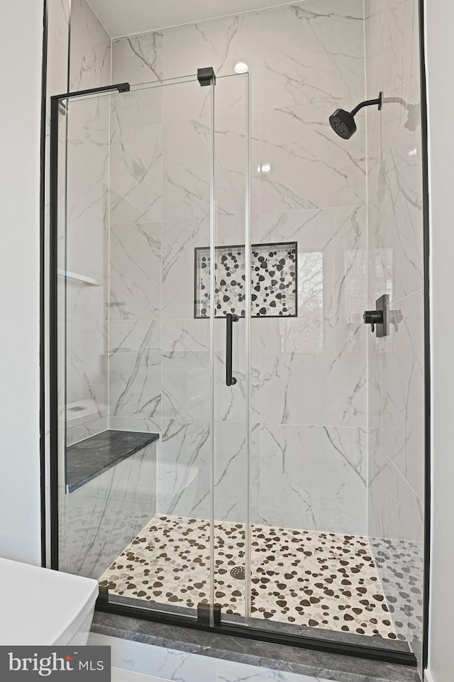 bathroom with a shower with shower door