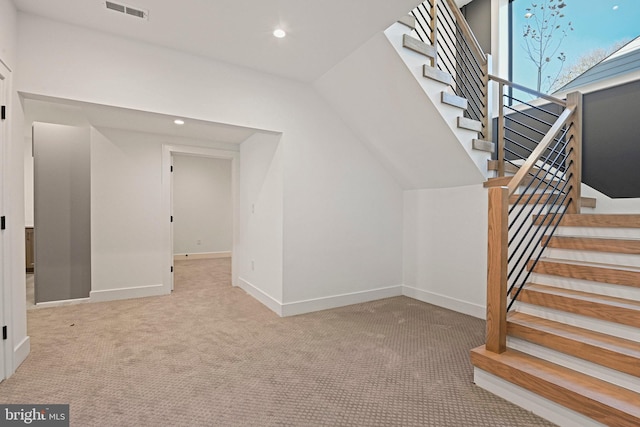 interior space featuring carpet flooring and lofted ceiling