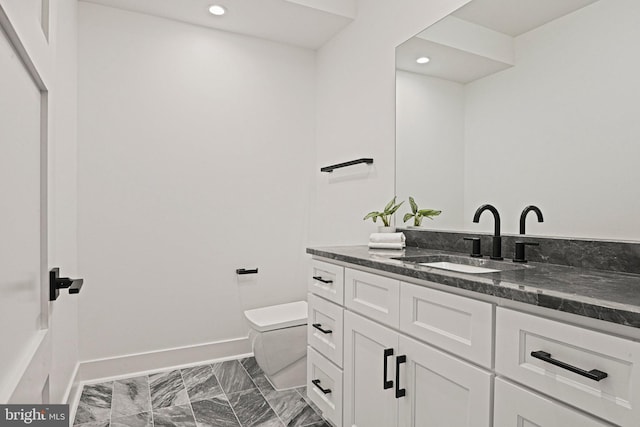 bathroom with vanity and toilet