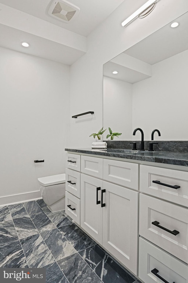 bathroom with vanity and toilet