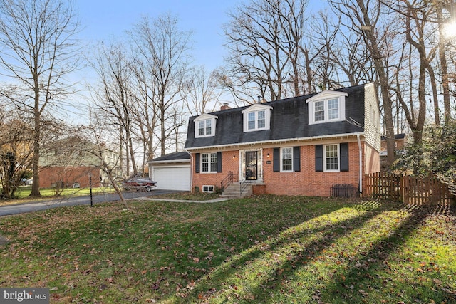 cape cod house with a front lawn and a garage