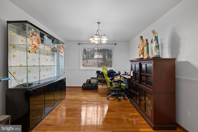 office space with a chandelier and wood-type flooring