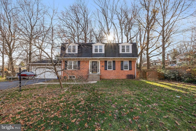 cape cod home with a garage and a front lawn