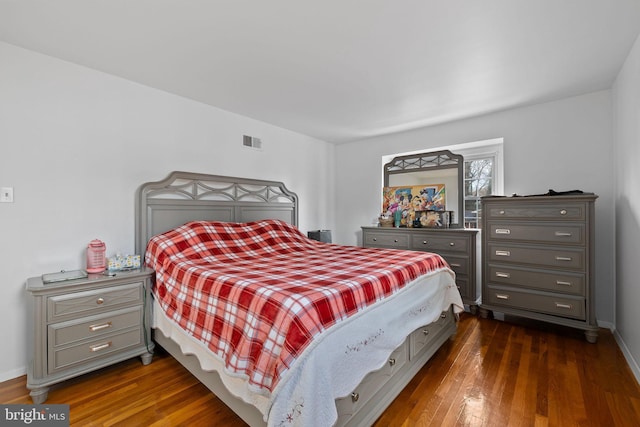 bedroom with dark wood-type flooring