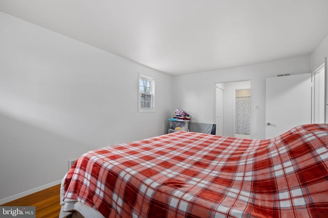 bedroom with wood-type flooring