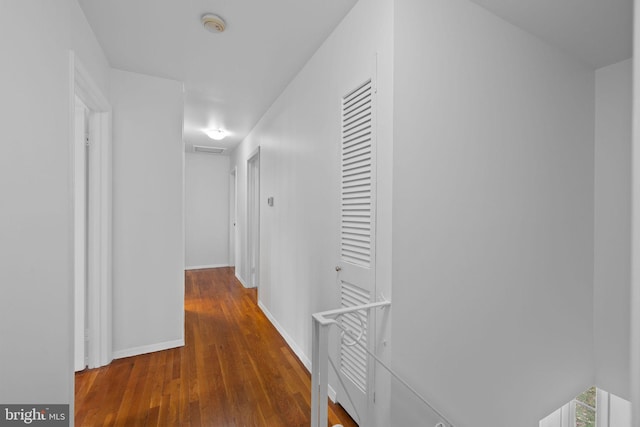 hallway with dark hardwood / wood-style flooring