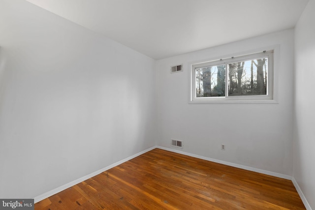 spare room with wood-type flooring