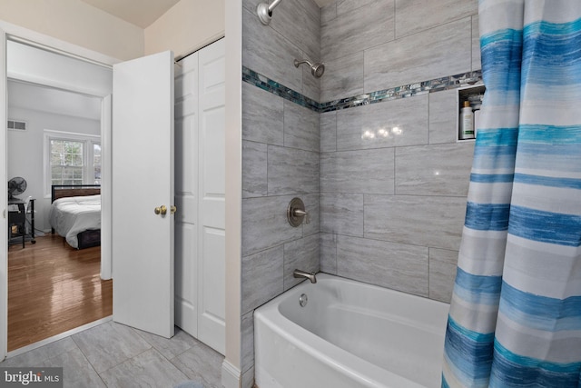 bathroom with wood-type flooring and shower / bath combination with curtain