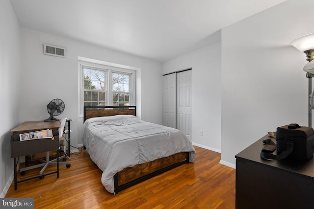 bedroom with wood-type flooring and a closet