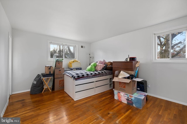 bedroom with dark hardwood / wood-style floors