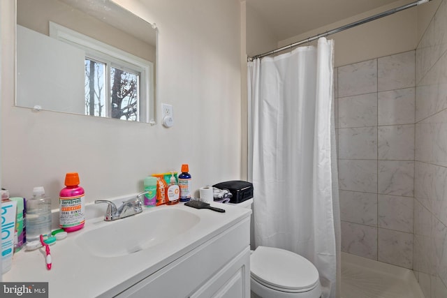 bathroom featuring vanity, toilet, and walk in shower