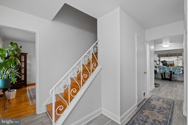 stairs featuring wood-type flooring