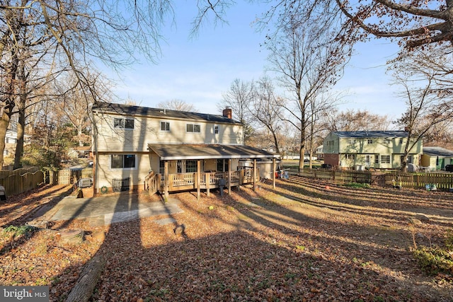 back of house featuring a wooden deck