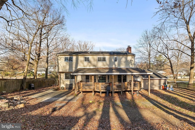 rear view of house featuring a deck