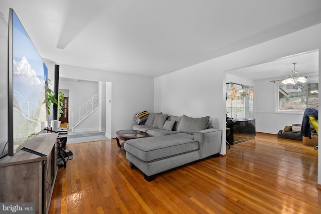 living room featuring an inviting chandelier and hardwood / wood-style flooring