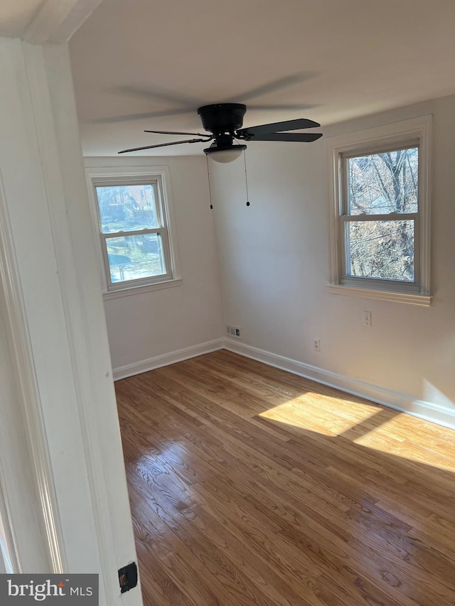 spare room with wood-type flooring and ceiling fan