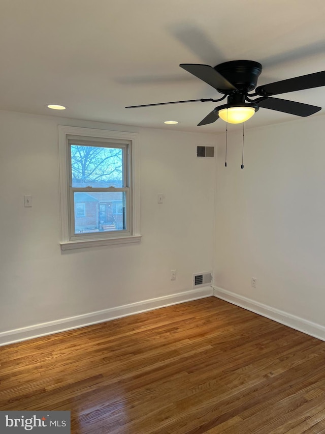 spare room with dark hardwood / wood-style floors