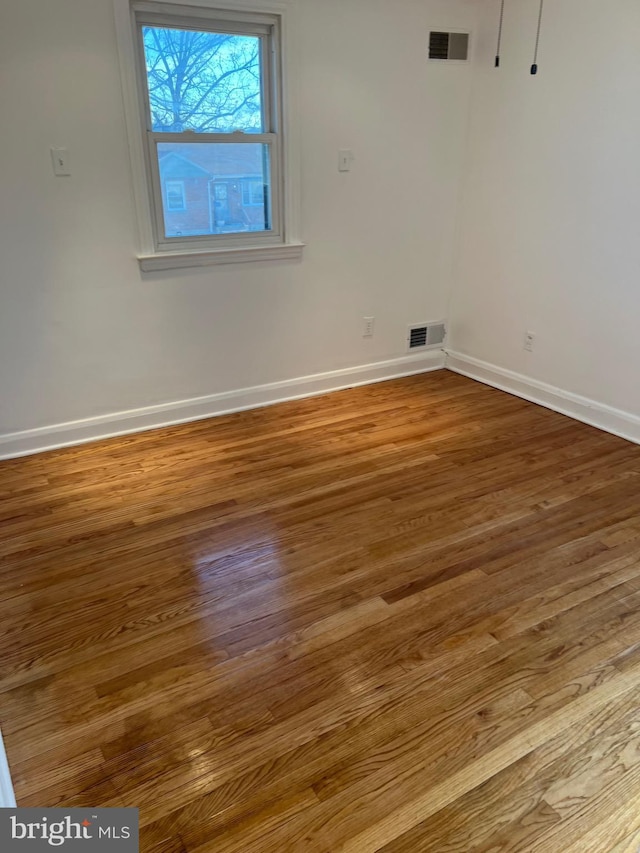 unfurnished room featuring hardwood / wood-style floors