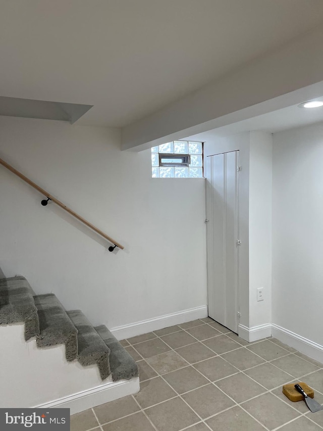 staircase featuring tile patterned flooring