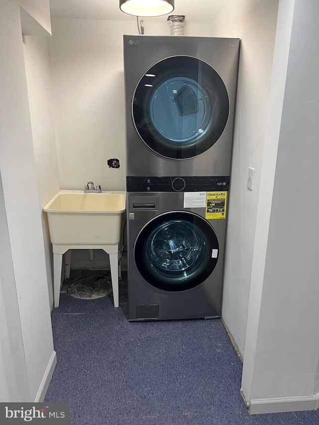 laundry room featuring stacked washer and clothes dryer