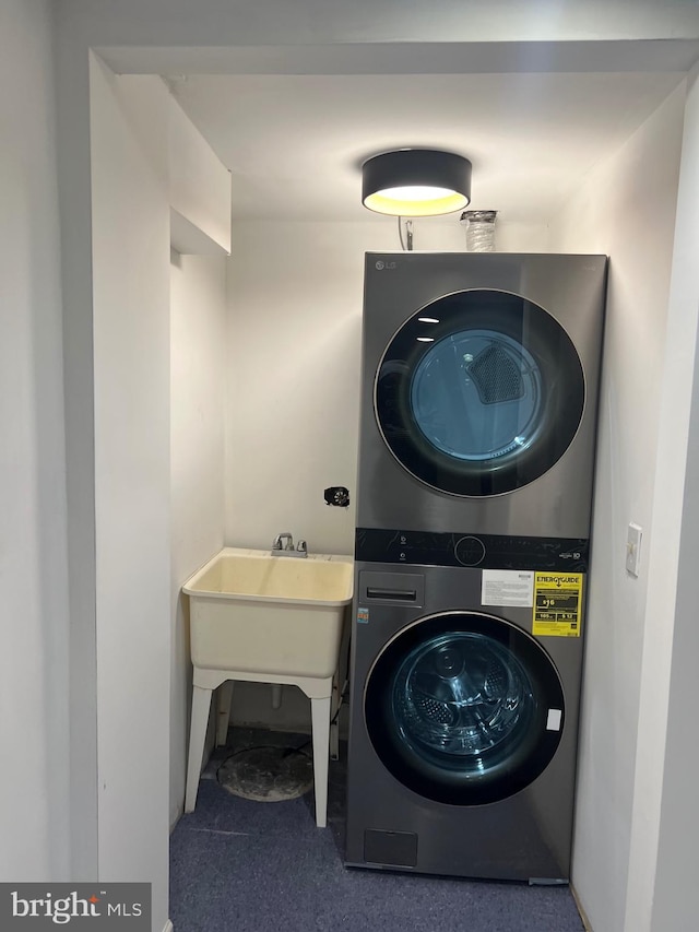 washroom featuring stacked washer and dryer