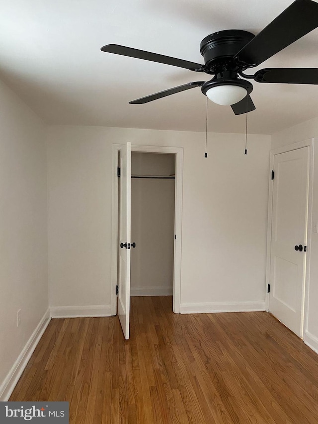 unfurnished bedroom featuring ceiling fan and wood-type flooring