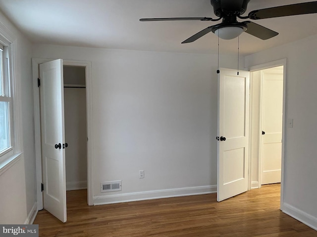 unfurnished bedroom featuring hardwood / wood-style floors and ceiling fan