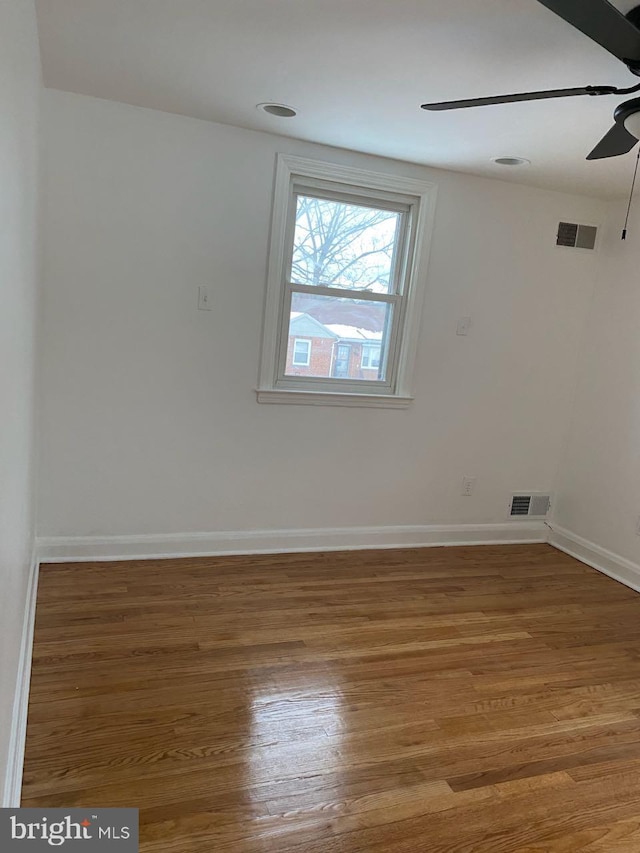 empty room featuring hardwood / wood-style flooring and ceiling fan