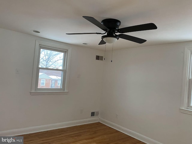 empty room featuring dark hardwood / wood-style floors and ceiling fan