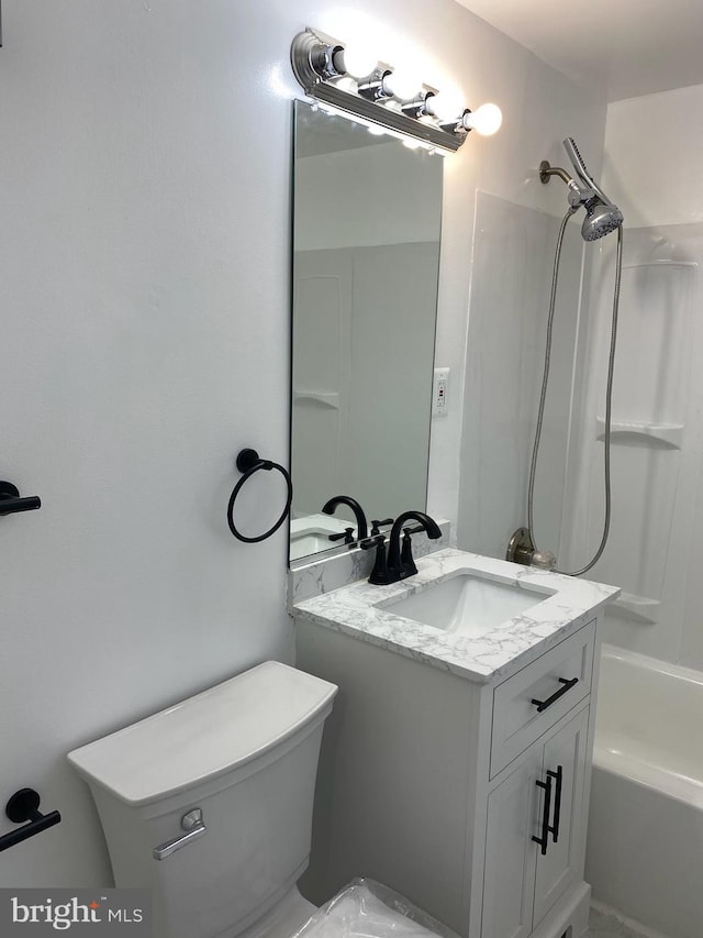 full bathroom with toilet, vanity, and shower / washtub combination