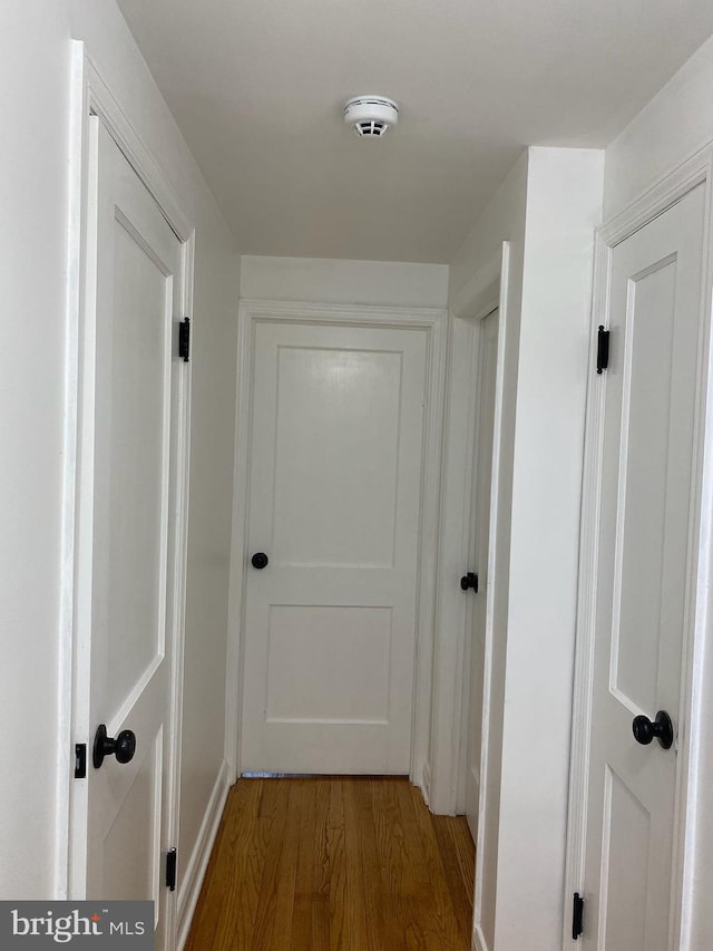 hallway with wood-type flooring