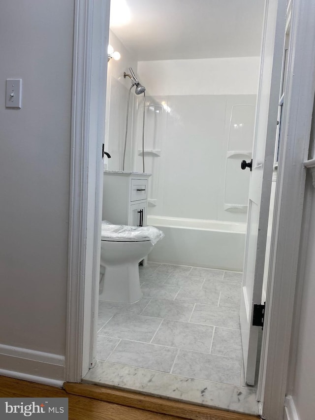 bathroom with shower / bathtub combination and toilet