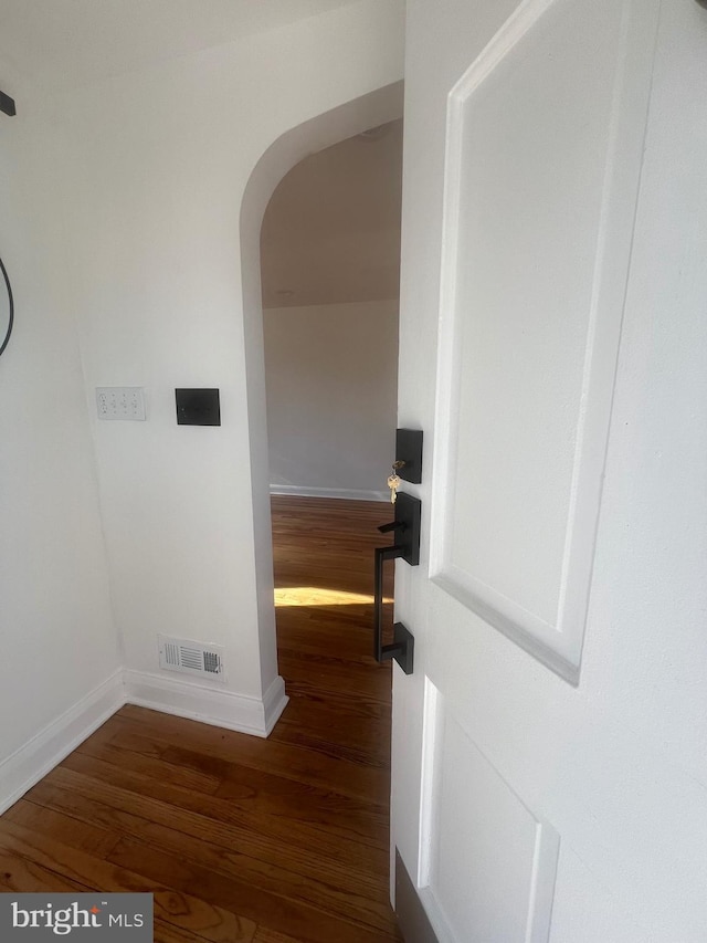 corridor featuring dark hardwood / wood-style floors