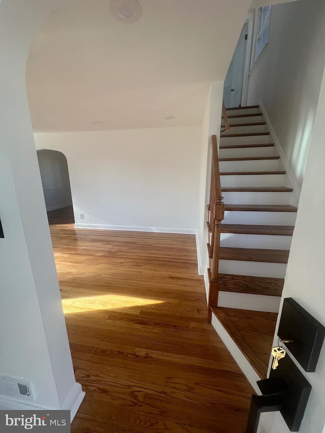 stairs featuring hardwood / wood-style floors