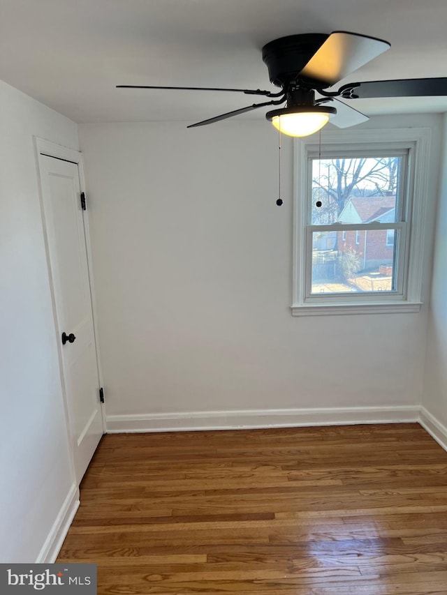 unfurnished room with hardwood / wood-style floors and ceiling fan