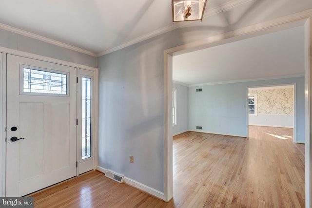 entrance foyer with light wood-type flooring and crown molding