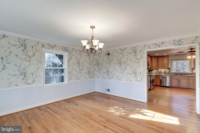 unfurnished dining area featuring light hardwood / wood-style floors, crown molding, and sink