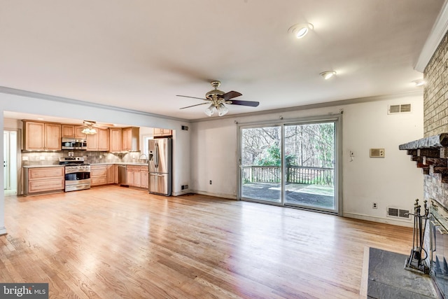 unfurnished living room with light hardwood / wood-style floors, a brick fireplace, and crown molding